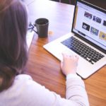 Woman working on laptop.
