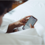 : A woman uses her smartphone for commerce, which Darren and Mike advise business owners to use