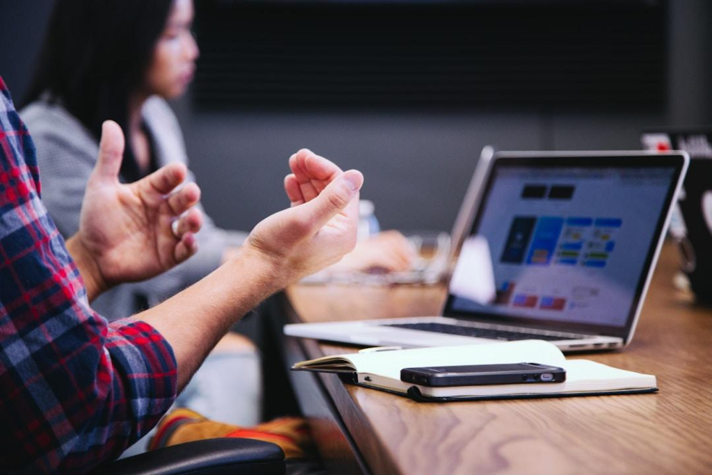 Alt text: A team in an office discussing digital customer service during a meeting